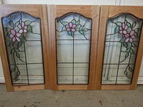 Three floral leadlight panels in timber frames