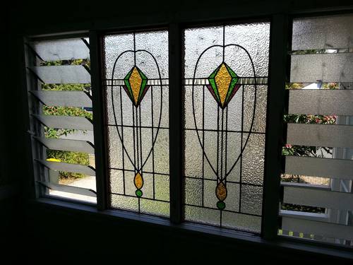 Geometric leadlight windows with amber diamond centres